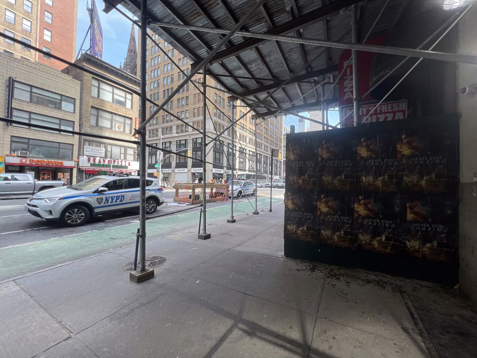 Never Stop Chasing wild posting at 350 7th Ave, Garment District, Manhattan